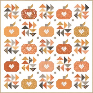 May include: A patchwork quilt with pumpkin motifs, each with a heart-shaped design. The pumpkins are orange, set against a white background, and surrounded by triangles in various colors. The quilt is a decorative item.