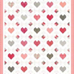 May include: A quilt with a white background and a pattern of pink, red, and gray hearts. The hearts are arranged in a grid pattern and are surrounded by a pink border.