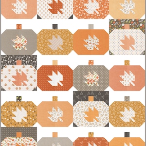 May include: A patchwork quilt featuring a repeating pattern of stylized pumpkins. Each pumpkin block is a different shade of orange, tan, and gray, with a leaf applique. The leaves are white or orange, and the pumpkin stems are dark brown.