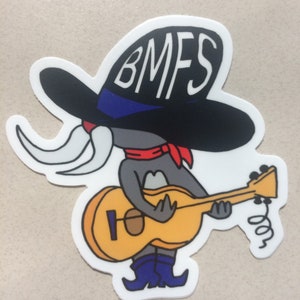 May include: A cartoon character wearing a black cowboy hat with the text "BMFS" on it, playing a yellow guitar. The character has a gray body, a red bandana, and blue boots.