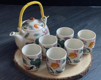 Keramische Japanse Chinese theepot en set van 6 theekopjes met roestvrijstalen zetgroep