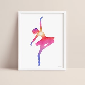 Sunset ballerina watercolor art print displayed in a white picture frame on a neutral background.