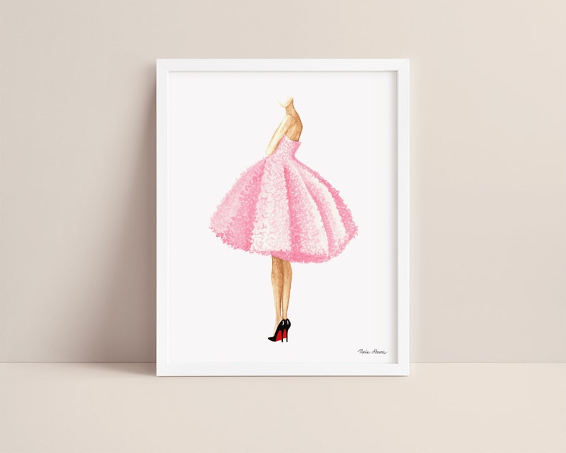 Pink dress fashion illustration displayed in a white picture frame on a neutral background.