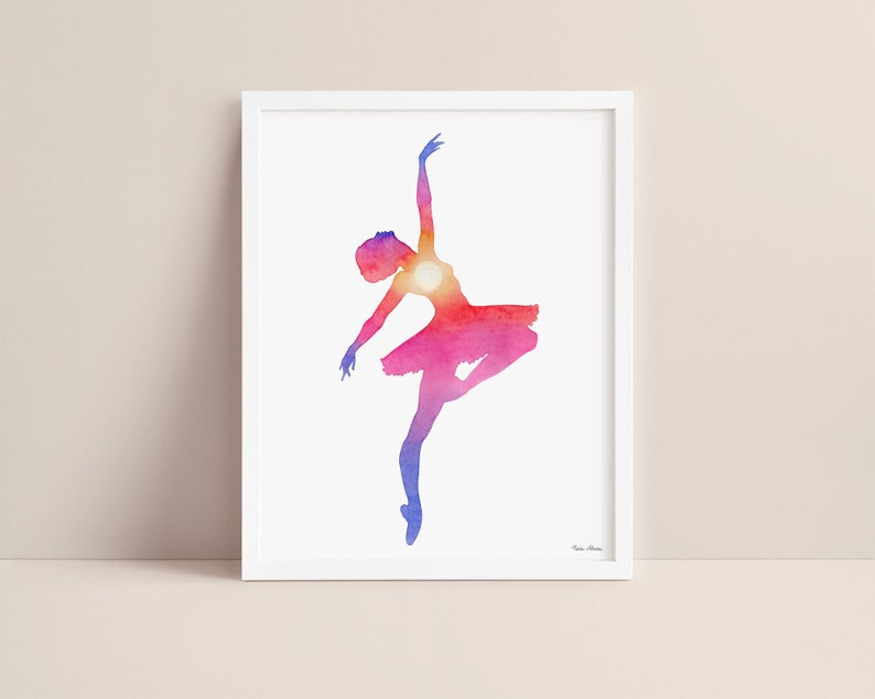 Sunset ballerina watercolor art print displayed in a white picture frame on a neutral background.