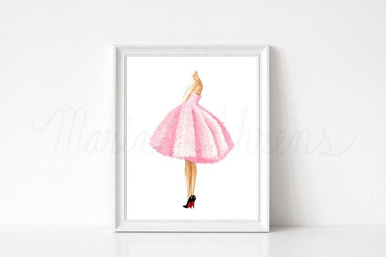 Pink dress watercolor fashion illustration displayed in white picture frame on a white background. Original artwork is by artist Maria Ahrens.