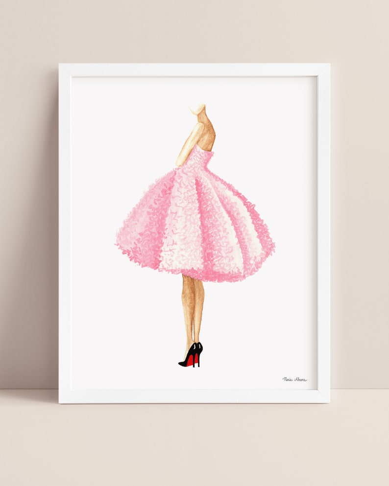 Pink dress fashion illustration displayed in a white picture frame on a neutral background.