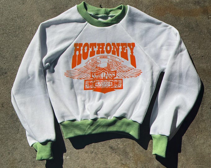 The “Hot Honey Eagle” White Cropped Raglan Sweatshirt