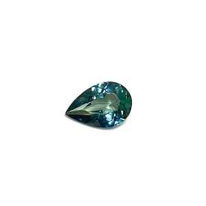 May include: A teardrop-shaped gemstone with a blue-green hue.
