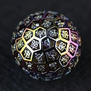 May include: A 100-sided die with a rainbow iridescent finish. The die is made of metal and has a geometric design with numbers 1-100 printed on each face.