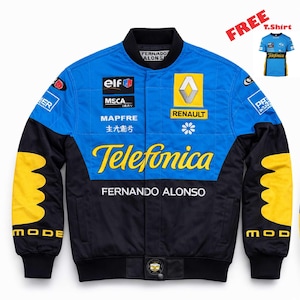 May include: A blue and black racing jacket with yellow and white accents. The jacket features the text "Telefonica" and "Fernando Alonso" in yellow, along with various sponsor logos. A free T-shirt is included.