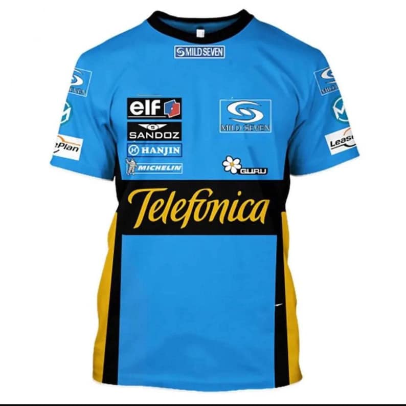 May include: A light blue short-sleeved t-shirt with black and yellow accents. The shirt features multiple sponsor logos, including "Telefonica" in yellow, and "Mild Seven". The shirt has a crew neck.
