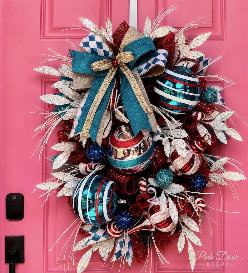 Retro Christmas swag with teal and gold bow, red and teal striped ornaments, candy cane patterns, and white glittered foliage