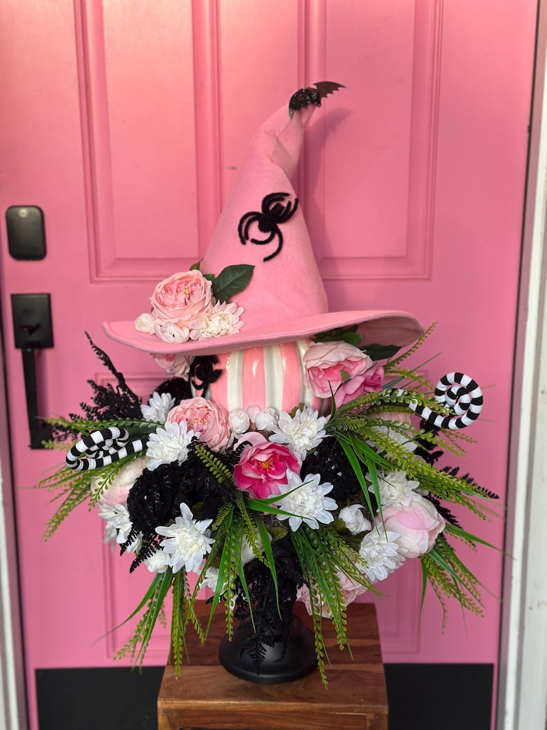 Witch Hat Pumpkin Centerpiece — pink witch hat with a black spider and florals atop a pink and white striped pumpkin