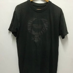 May include: Black t-shirt with a graphic print of a winged eagle with the text "Rows Zero" and "Downtown LA" underneath.