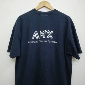 May include: A dark blue t-shirt with a white logo that says "AMX Advanced Control Systems".
