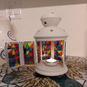Multicoloured stained glass mosaic on white tealight lantern