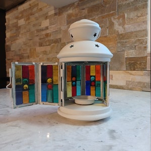 Multicoloured stained glass and gems mosaic on white tealight lantern