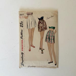 May include: Vintage Simplicity printed sewing pattern 2017. The pattern features illustrations of three skirt designs. The cover includes the text "Size 18, Bust 36" and "Simple to Make". The pattern is printed on each piece.