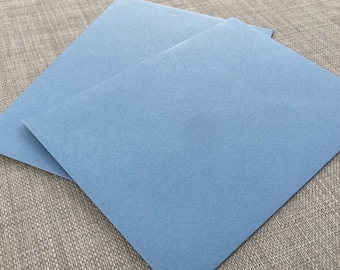 May include: Two pieces of light blue cardstock paper stacked on top of each other.