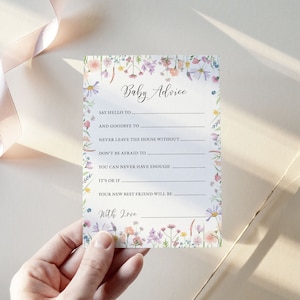 Baby Advice Baby shower game card featuring a pink, yellow, Lilac and peach wildflower design on a white background. Shown being held