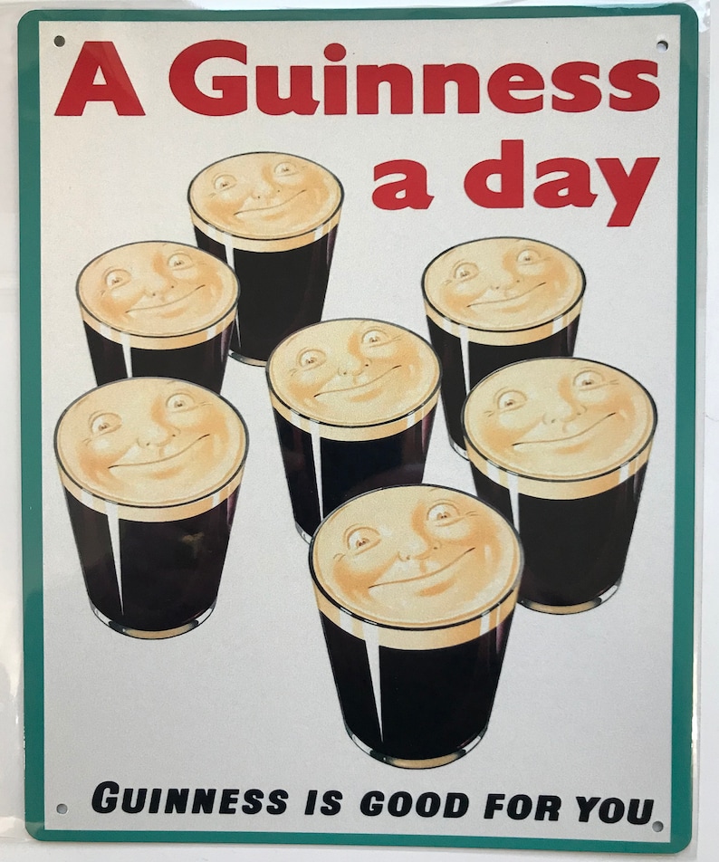 May include: A vintage metal sign with a green border and white background. The sign features a red and white text that reads "A Guinness a day". The sign also features six glasses of Guinness with smiling faces on the top of the foam. The text "GUINNESS IS GOOD FOR YOU" is printed in black at the bottom of the sign.