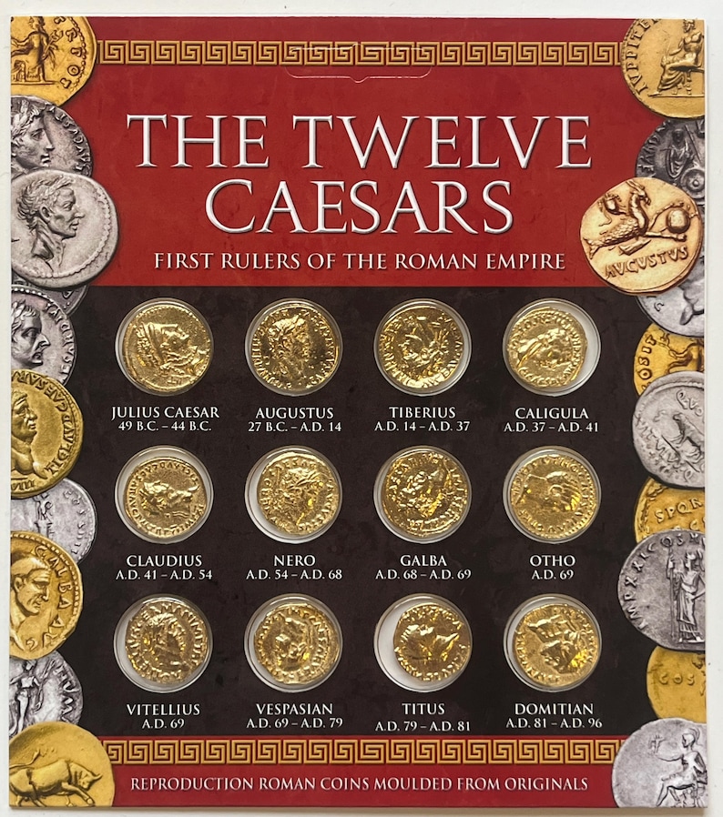 May include: A set of twelve gold-colored reproduction Roman coins featuring the images of the first twelve Roman emperors. The coins are arranged in a grid on a red background with the title "The Twelve Caesars" and "First Rulers of the Roman Empire".