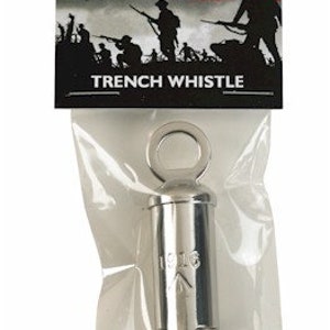 May include: A silver World War I trench whistle with a ring on top. The whistle is packaged in a clear plastic bag with a red poppy and soldier silhouette graphic on the packaging. The packaging also says "World War I Trench Whistle".