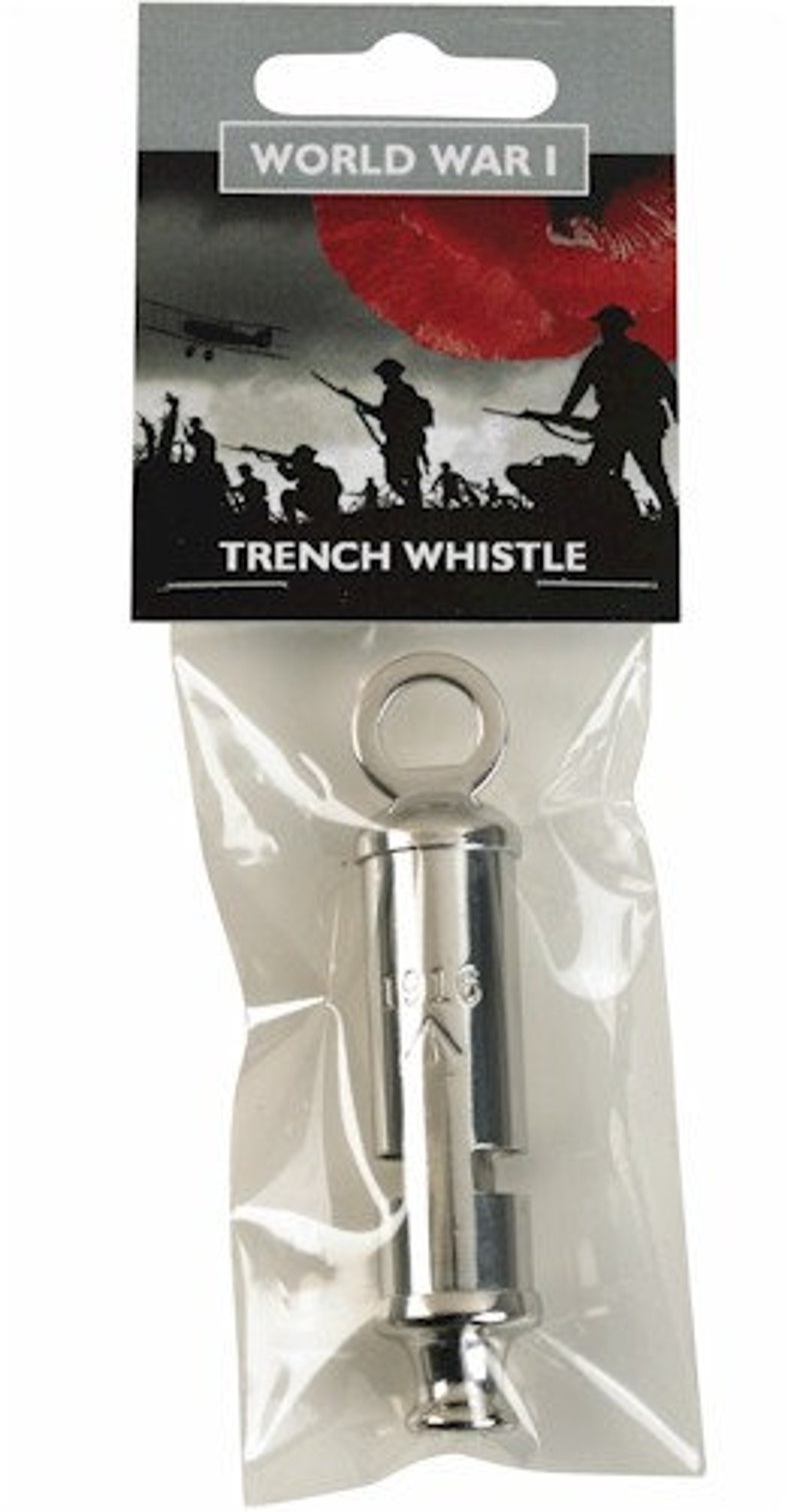 May include: A silver World War I trench whistle with a ring on top. The whistle is packaged in a clear plastic bag with a red poppy and soldier silhouette graphic on the packaging. The packaging also says "World War I Trench Whistle".