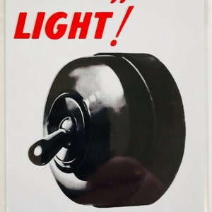 May include: A white metal sign with red and black text that reads "Switch off that LIGHT!" and "LESS LIGHT - MORE PLANES". The sign features a black and white illustration of a light switch.