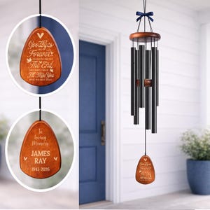 Personalized memorial wind chimes with custom engraved wood sail, sympathy gift for loss of loved one, outdoor remembrance decor. Black aluminum tubes hang from a walnut wood top with navy ribbon on a bright white farmhouse porch. Close-up engraving reads “Goodbyes are not forever… I’ll miss you until we meet again” and “In Loving Memory James Ray 1943–2026,” meaningful bereavement keepsake.