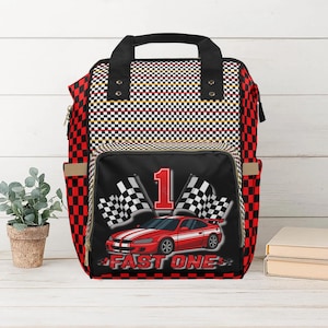 Racing toddler travel backpack with car and checkered flag design. Perfect for preschool, daycare, or road trips. Durable and roomy toddler bag for travel.
