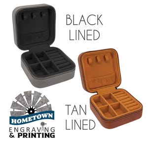 Two travel jewelry cases are shown, one with a black interior lining and the other with a tan interior lining. The cases are compact, zippered, and designed for organizing rings, earrings, and necklaces. The Hometown Engraving & Printing logo is displayed, indicating customization options.