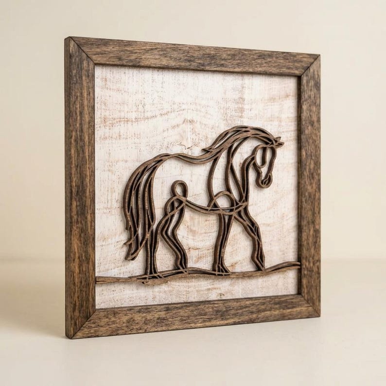 May include: Wooden framed art piece featuring a horse and rider silhouette. The artwork is crafted from layered wood, creating a 3D effect. The frame is a rustic brown, and the background is a distressed white.