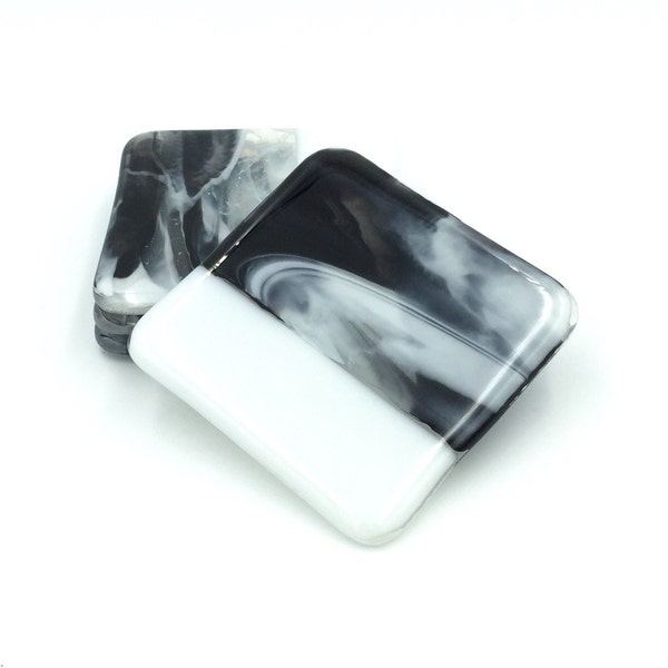 Glass coasters in white, black, and clear (set of four)