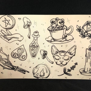 May include: A black and white illustration of a variety of mystical and occult objects, including a pentagram, a cat, a skull, a potion bottle, a teacup, a candle, a mushroom, and a 20-sided die.