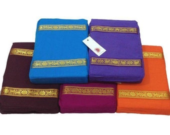 May include: Five meditation cushions in different colors, including purple, blue, maroon, pink, and orange. Each cushion has gold trim and is made of fabric.