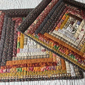 May include: A handmade wooden sign displaying the word "Welcome" in a whimsical font. The sign is painted white with a distressed finish, and features a floral design in pinks and greens. Designed for door or wall hanging.