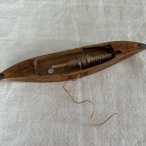An Antique Swedish Weaving Shuttle with Metal Ends and Carved Detail