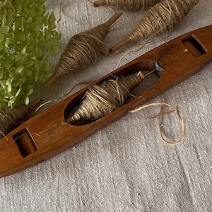 An Antique Swedish Boat Shuttle with Rollers for Weaving Swedish Weaving Shuttle