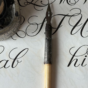 An Antique Bone Handled Dip Pen with 2 vintage metal nibs