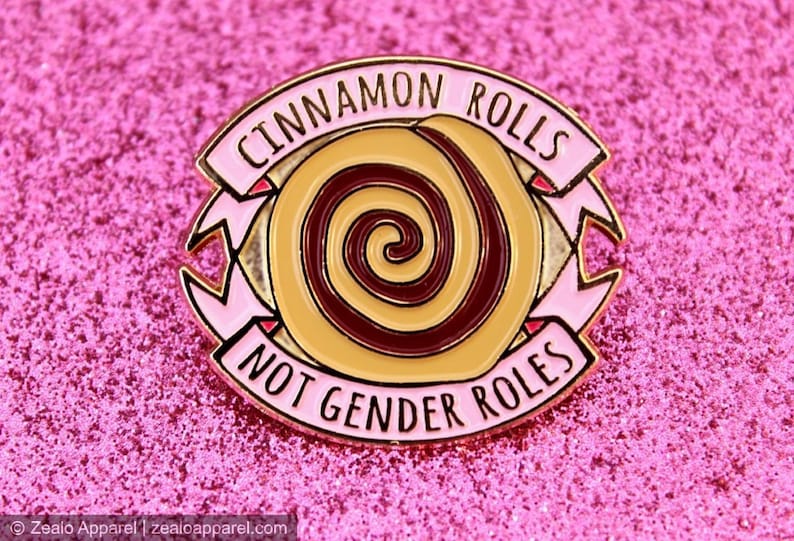  Cinnamon Rolls Not Gender Roles Feminist Enamel Pin with a cinnamon role at the center