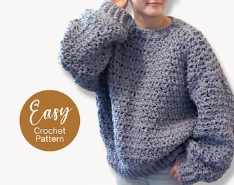 Peut inclure: Un pull en crochet gris avec un col rond et des manches longues. Le pull est réalisé avec un point texturé et a une coupe ample. Le texte "Easy Crochet Pattern" est écrit en blanc sur un cercle brun.