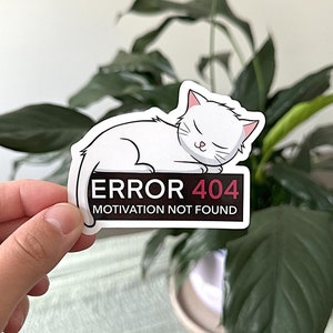 May include: White cat cartoon sticker with the text "ERROR 404 MOTIVATION NOT FOUND" in black and red.