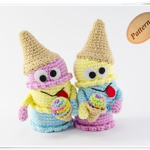 May include: Two crocheted ice cream cone characters with googly eyes and smiling faces. The ice cream cone characters are holding colorful ice cream cones. The characters are made with pink, yellow, blue, and beige yarn.