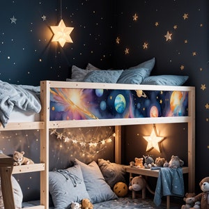 May include: A wooden bunk bed with a space-themed headboard featuring planets and stars. The bed is decorated with string lights, stuffed animals, and a plush rug. The room is painted a dark blue and has gold stars on the wall.