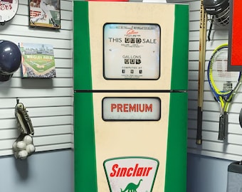 May include: A vintage Sinclair gas pump painted green with a cream-colored center panel. The pump features the Sinclair logo with a dinosaur and the words "Premium" and "This Old Sale". The pump is on wheels.
