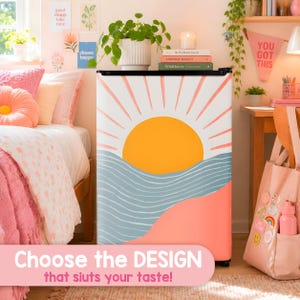 May include: A compact refrigerator featuring a graphic print of a yellow sun rising over blue wavy lines and a solid coral base. The front of the appliance displays a stylized landscape design with radiating sunbeams against a white background.