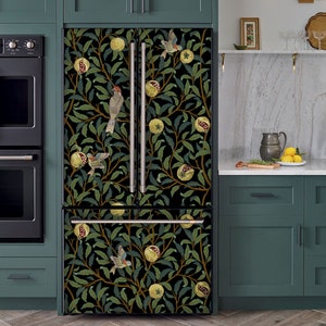 May include: A black refrigerator with a floral design featuring pomegranates, leaves, and birds. The design is in shades of green, yellow, and brown on a black background.