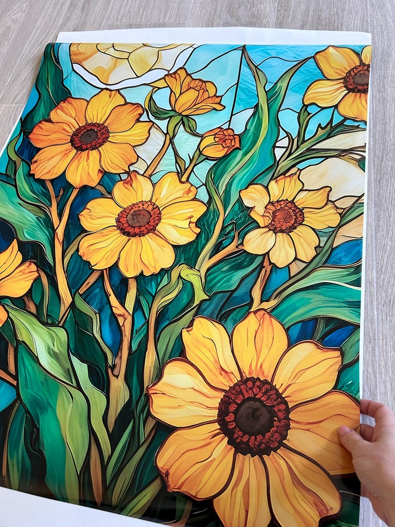 May include: A stained glass style print featuring yellow flowers with brown centers and green leaves on a blue background.
