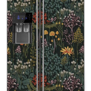 May include: A black refrigerator with a floral pattern on the doors. The pattern features a variety of flowers, leaves, and stems in shades of red, orange, yellow, green, and pink. The refrigerator has a water and ice dispenser on the door.